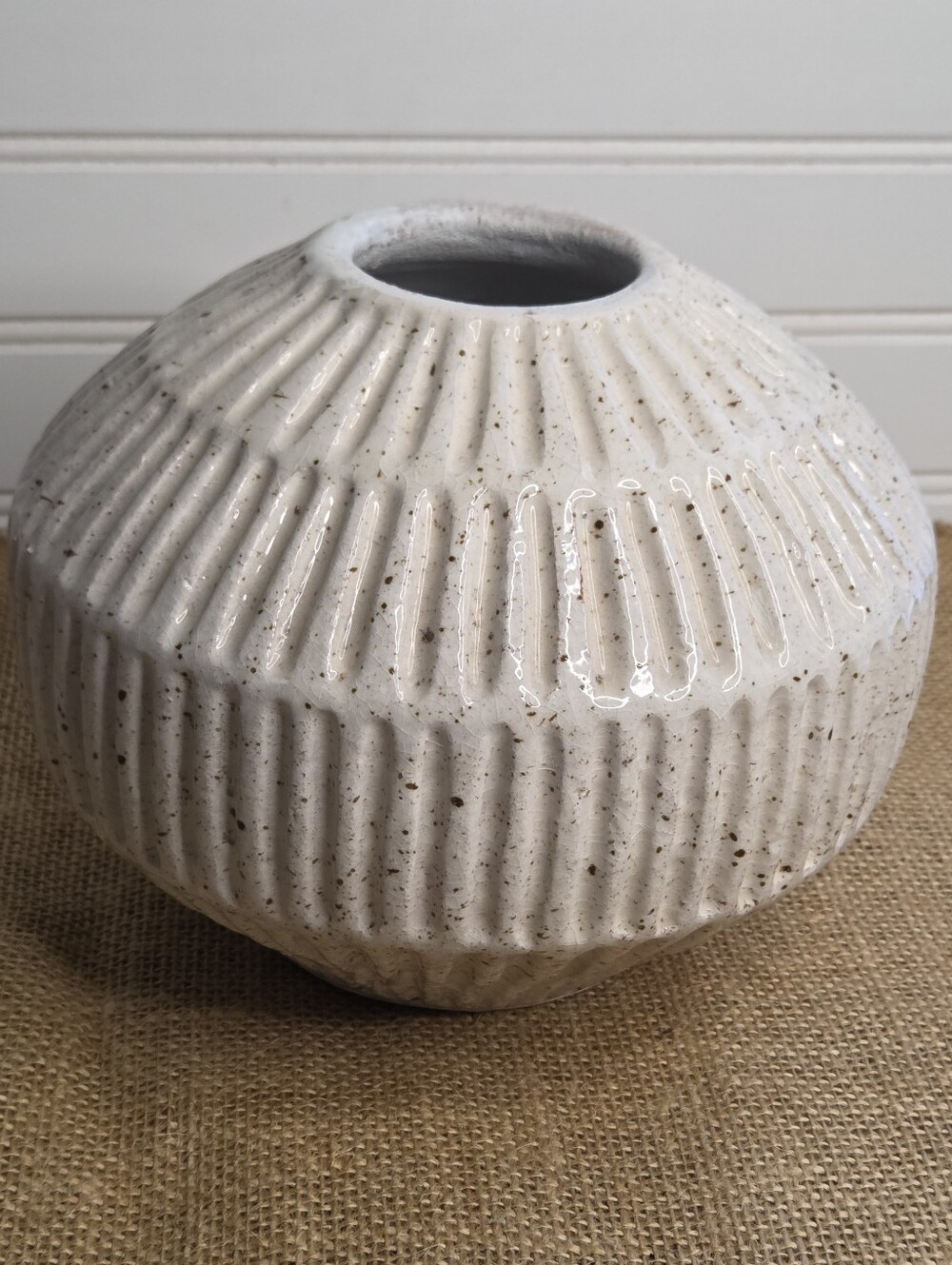 Studio McGee Small Carved Cream Vase features ribbed texture and speckled white